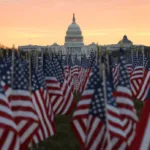 WASHINGTON, DC - JANUARY 18: The U.S Capitol Building is prepared for the inaugural ceremonies for President-elect Joe Biden as American flags are placed in the ground on the National Mall on January 18, 2021 in Washington, DC. The approximately 191,500 U.S. flags will cover part of the National Mall and will represent the American people who are unable to travel to Washington, DC for the inauguration. (Photo by Joe Raedle/Getty Images)